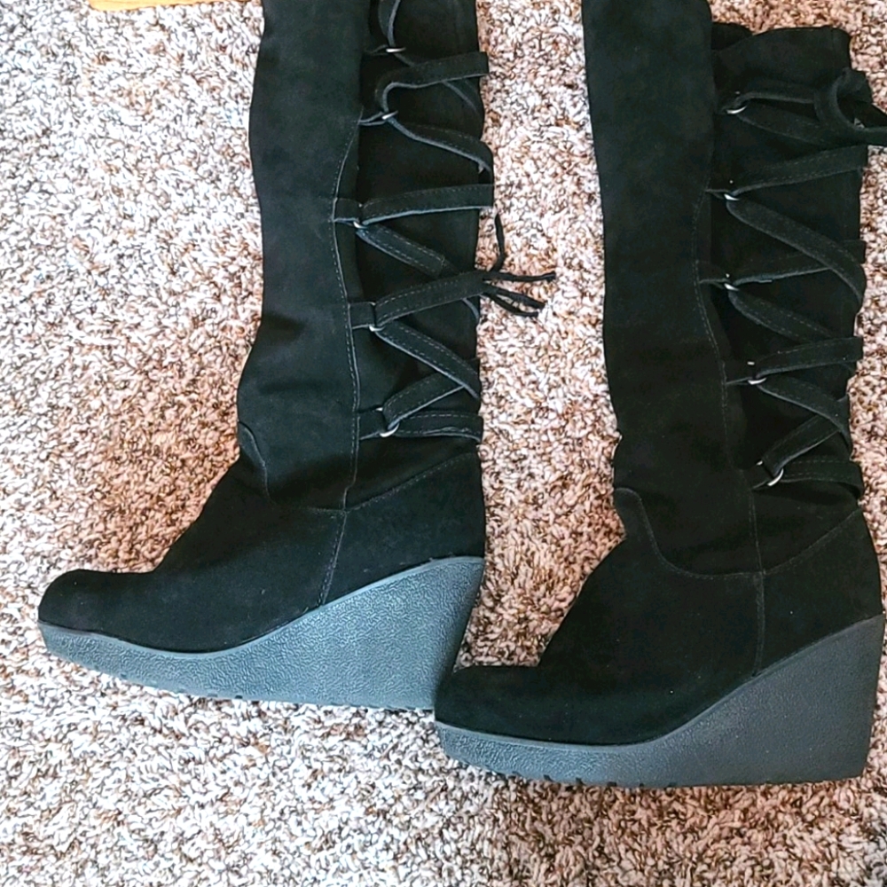 Winter knee high black wedge boots .